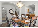 Elegant dining room featuring a glass-top table with seating for six and stylish decor at 936 Lake Berkley Dr, Kissimmee, FL 34746