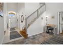Bright foyer with staircase, neutral walls, and decorative rugs that welcome you into the home at 936 Lake Berkley Dr, Kissimmee, FL 34746