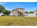 Expansive backyard with a well-maintained lawn and a white fence, offering plenty of outdoor space at 102 Deen Blvd, Auburndale, FL 33823