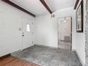 Bright entryway featuring tiled floors, a white brick accent wall, and a view into the adjacent rooms at 1024 Campbell Ave, Lake Wales, FL 33853