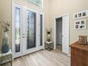 An open foyer featuring a decorative glass front door and sidelights, with tile floors and access to a closet at 1104 Sawgrass Dr, Winter Haven, FL 33884