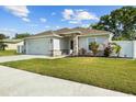 Well-maintained lawn and landscaping enhance the curb appeal of this lovely home at 1221 Alameda S Dr, Lakeland, FL 33805