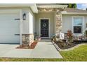 Charming front entrance featuring a decorative wreath and stone accents at 1221 Alameda S Dr, Lakeland, FL 33805