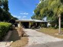 Charming single story home with mature landscaping, metal roof and driveway at 124 Palm Pl, Haines City, FL 33844
