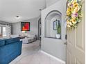 Inviting foyer with an archway leading into the living room; stylish décor with tile flooring at entrance at 1357 Rebecca Dr, Haines City, FL 33844