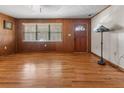 Spacious living room featuring beautiful hardwood floors, wood paneling and ample natural light at 1371 Sheridan Sw St, Winter Haven, FL 33880
