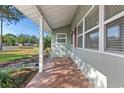 The home has a quaint, covered front porch with red terracotta style tile at 1371 Sheridan Sw St, Winter Haven, FL 33880