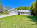 Charming single Gathering home with a well manicured lawn and two-car garage at 14 Cypress Run, Haines City, FL 33844