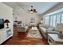 Bright living room features hardwood floors, neutral decor, and lots of natural light at 14 Cypress Run, Haines City, FL 33844
