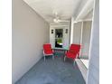 Inviting front porch with two chairs for relaxing and enjoying the outdoors at 14 Cypress Run, Haines City, FL 33844