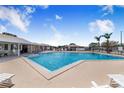 Beautiful community pool with lounge chairs and a covered seating area, perfect for relaxation at 151 Winter Ridge Dr # 151, Winter Haven, FL 33881