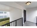 Exterior view of front door for unit E7 with black railing at 1550 11Th Ne St # E7, Winter Haven, FL 33881