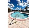 Resort style pool with blue skies and palm trees in a beautiful community at 1820 Coriander Dr, Poinciana, FL 34759