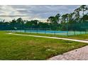 Well maintained tennis court with green surroundings and a peaceful atmosphere at 1820 Coriander Dr, Poinciana, FL 34759