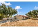 Inviting one-story home with an attached garage, well-maintained lawn, and flagpole displaying the American flag at 211 Pierce St, Lake Wales, FL 33859