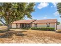 Lovely single-story home with a screened-in porch and neatly landscaped garden beds in the front yard at 211 Pierce St, Lake Wales, FL 33859