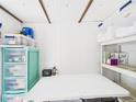 Organized storage area with white shelves, plastic bins, and a folding table at 2222 12Th Nw St, Winter Haven, FL 33881