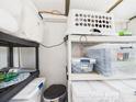 Efficient storage solution with plastic bins and shelves in a well-organized space at 2222 12Th Nw St, Winter Haven, FL 33881