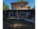 Exterior view of a two story house with visible windows, gutters and backyard at 229 Ne Avenue B, Winter Haven, FL 33881