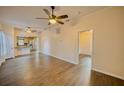 Spacious living room featuring wood-look floors, ceiling fans, and natural light at 230 Denton Ave, Auburndale, FL 33823
