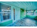 Inviting front porch with unique mosaic tile flooring and ample natural light at 230 Denton Ave, Auburndale, FL 33823