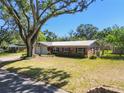 Charming brick home with a well-maintained lawn and metal roof at 2640 Handley Blvd, Lakeland, FL 33803