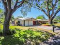 Beautiful home with a red door, well-maintained landscaping, and a spacious two-car garage at 2640 Handley Blvd, Lakeland, FL 33803