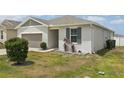 Well-maintained single-story home with tidy lawn, simple landscaping, and 2-car garage at 287 Lake Smart Cir, Winter Haven, FL 33881