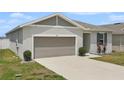 Charming single-story home featuring a 2-car garage and well-kept lawn with minimal landscaping at 287 Lake Smart Cir, Winter Haven, FL 33881