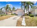Charming single-story home boasting a well-kept lawn, a two-car garage, and mature landscaping, creating curb appeal at 2960 Kokomo Loop, Haines City, FL 33844