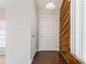 Cozy entryway with a wooden accent wall, and tile floor that provides a warm, inviting welcome at 3022 Lantana Rd, Auburndale, FL 33823