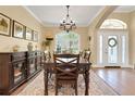 Formal dining room featuring a wooden table, chandelier, traditional decor, and large windows with views at 3158 Beauchamp Ct, Winter Haven, FL 33884