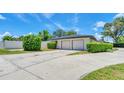 Spacious two-car garage with a long driveway and neatly trimmed landscaping at 333 Lake Otis Se Dr, Winter Haven, FL 33880