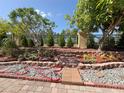 Backyard retreat featuring lush landscaping, a decorative fence, and a charming stone pathway at 4480 Turnberry Ln, Lake Wales, FL 33859