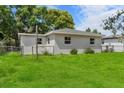 Exterior view showcasing a well-maintained yard and updated windows for energy efficiency at 4760 Holton Rd, Auburndale, FL 33823