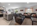 Open-concept living room and kitchen area with comfortable seating, tile floors, and lots of natural light at 500 Rio Grande Dr, Kissimmee, FL 34759