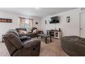 Cozy living room with a large sofa, TV, modern decor, and plush carpet for ultimate comfort and relaxation at 500 Rio Grande Dr, Kissimmee, FL 34759