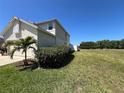 Side yard featuring mature landscaping and well maintained lawn at 502 Little Lake Ct, Winter Haven, FL 33884