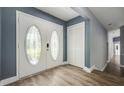 Inviting entryway featuring double doors with decorative glass and modern wood flooring at 6014 Crystal View Dr, Orlando, FL 32819