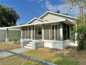 A cozy single-story home featuring a screened-in porch area at 602 Nw 1St Ave, Mulberry, FL 33860