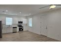 A well lit open kitchen featuring stainless steel appliances and an adjacent living space at 612 Sears Ne Ave, Winter Haven, FL 33881