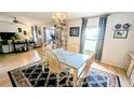Bright dining room with granite-topped table, display cabinet, and easy access to the living area at 6305 Bayberry Ne Blvd, Winter Haven, FL 33881