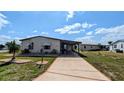 Single-story home with driveway and covered carport; perfect for parking and keeping vehicles protected at 6305 Bayberry Ne Blvd, Winter Haven, FL 33881