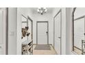 Welcoming foyer with neutral tones, stylish mirror, and convenient shoe rack at 6343 Torrington Cir, Lakeland, FL 33811
