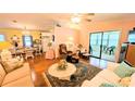 Bright living room with hard wood floors and access to the lanai at 6562 Chinaberry Ne Dr, Winter Haven, FL 33881