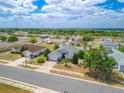 Wide angle shot of neighborhood featuring single story homes with modest landscaping and trees throughout at 799 Highland Crest Loop, Lake Wales, FL 33853