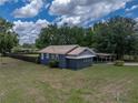 Low aerial view of the house with a well-maintained lawn and privacy fence at 803 7Th Ne St, Fort Meade, FL 33841
