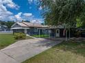 Inviting home featuring a covered parking area and an artificial grass area at 803 7Th Ne St, Fort Meade, FL 33841