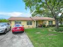 This house has a well-manicured lawn and a driveway with space for two cars at 808 Ware Ne Ave, Winter Haven, FL 33881