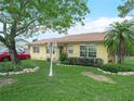 Quaint home with lush green lawn, stone accents, and a well-manicured garden bed at 808 Ware Ne Ave, Winter Haven, FL 33881